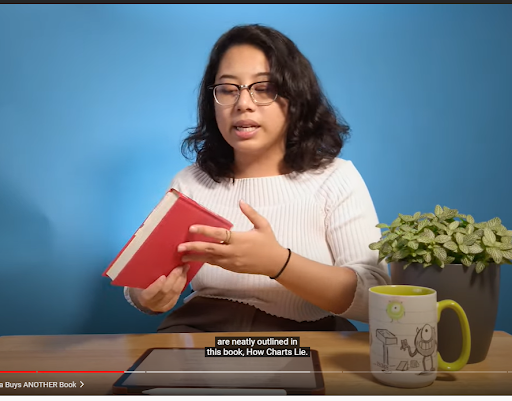 Person holding the now red book on the same blue background