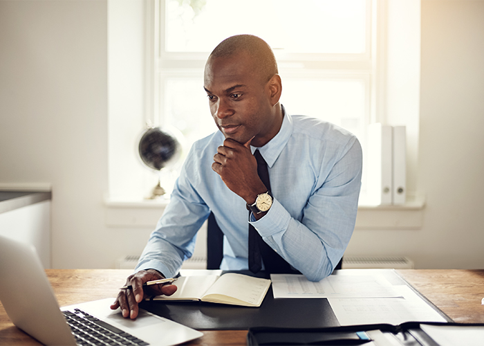 man at a desk working on his computer