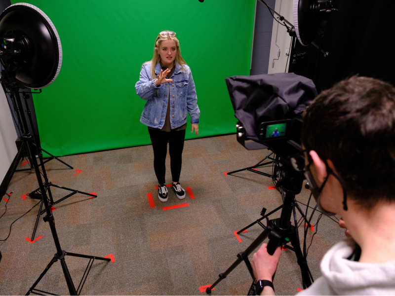A student using the green screen in the Gardner-Harvey Library