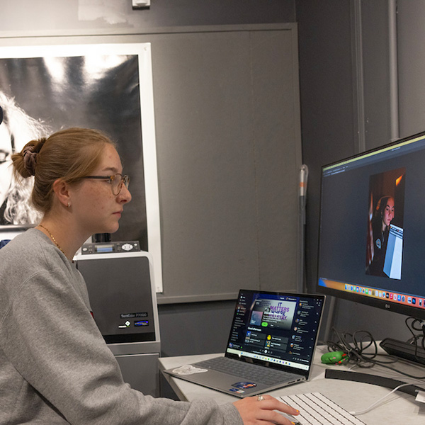 A woman using photoshop to edit a photo
