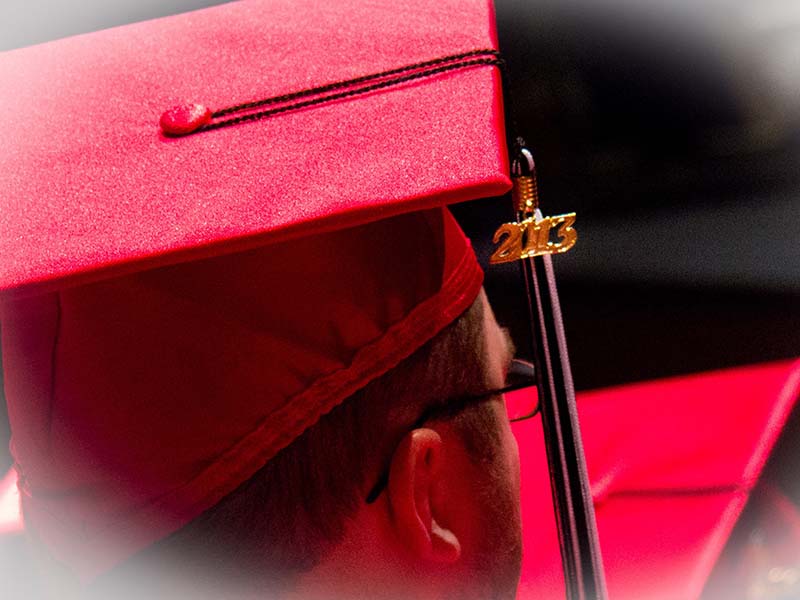 A side profile of a grad in their cap and gown