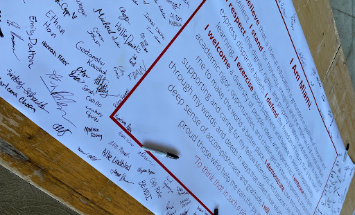Signatures on a code of love and honor banner.