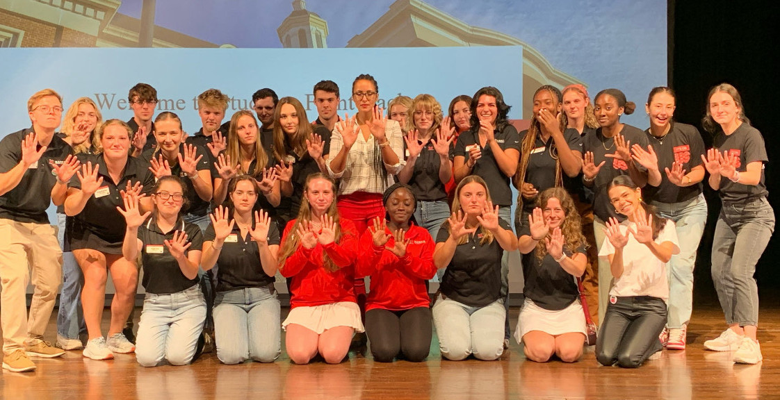 Large group of students posing on stage during the Students Fight Back program in September.