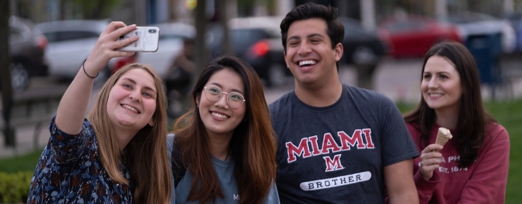 four Miami students uptown taking a selfie