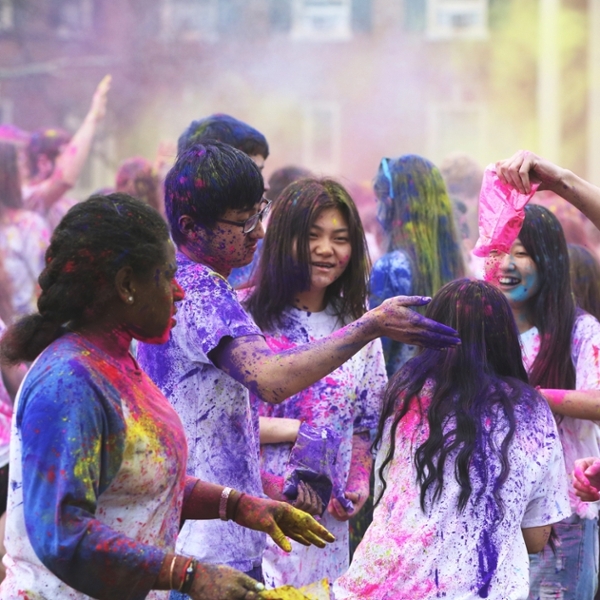  Group of 6 students wearing white shirts covered in different colored powders for the Color Run 5K