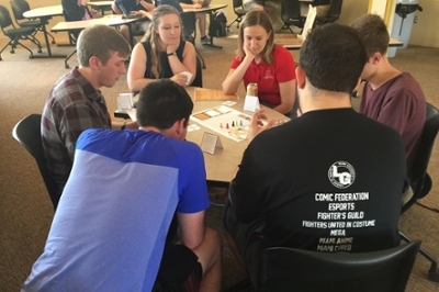  Students from EDL290 Table Top Games and Leadership play testing a student-created gam