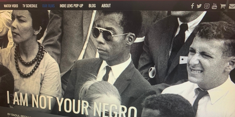 Laptop with open screen of black and white image on a website with words I am not your negro.