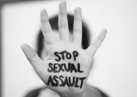 Hand held up with "Stop Sexual Assault" written on the hand