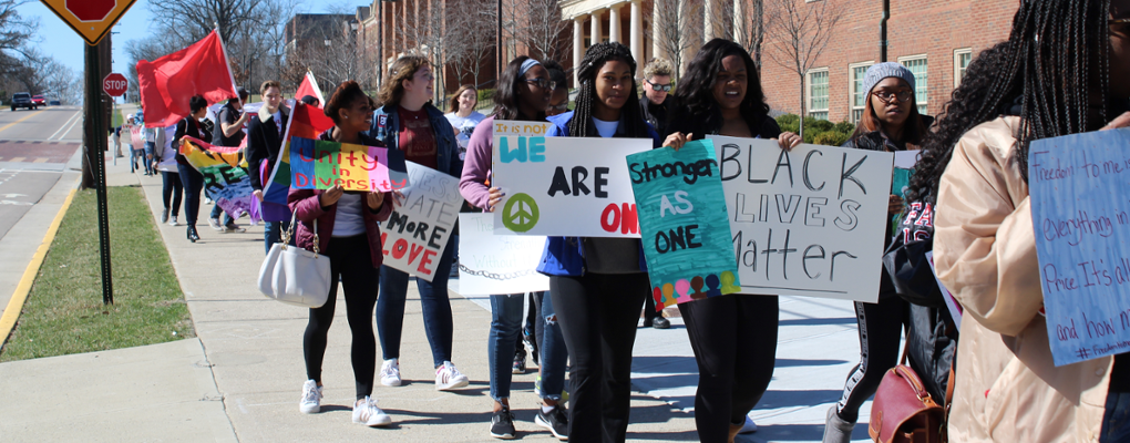  Students carrying signs during Unity Day March 2018 portraying social justice for different identities