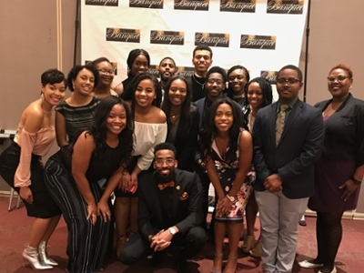  Director of The Office of Diversity Affairs and Assistant Director of Diverse Student Development posing for photograph along with their students after the Annual Black History Month Banquet.