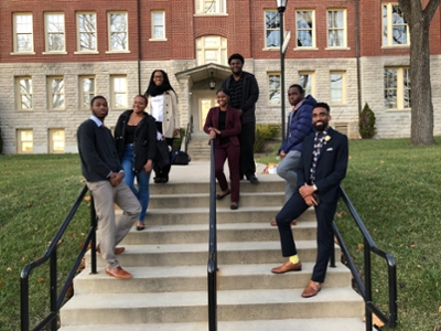 Assistant Director of Diverse Student Development and students from Central State University posing for a photo outside of McGuffey Hall after the 2017 Multicultural Student Leadership Conference.