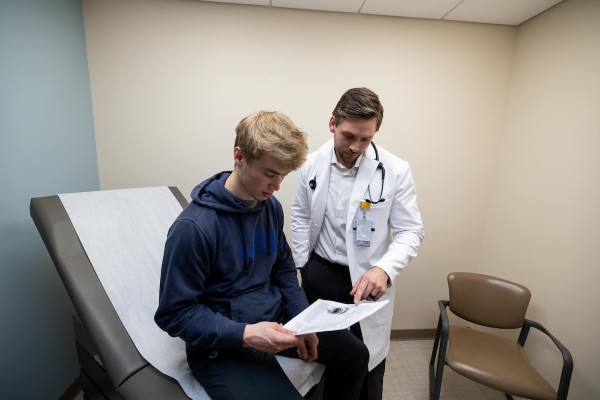 Doctor consulting with a male student.