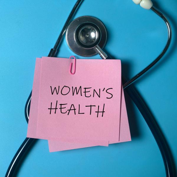 Women's Health written on a pink post-it note, with a stethoscope in the background 